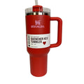Red Stanley tumbler with a white label on a white background